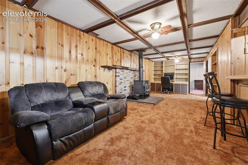 Image 23 of 30: Basement Family Room and Woodburning Stove