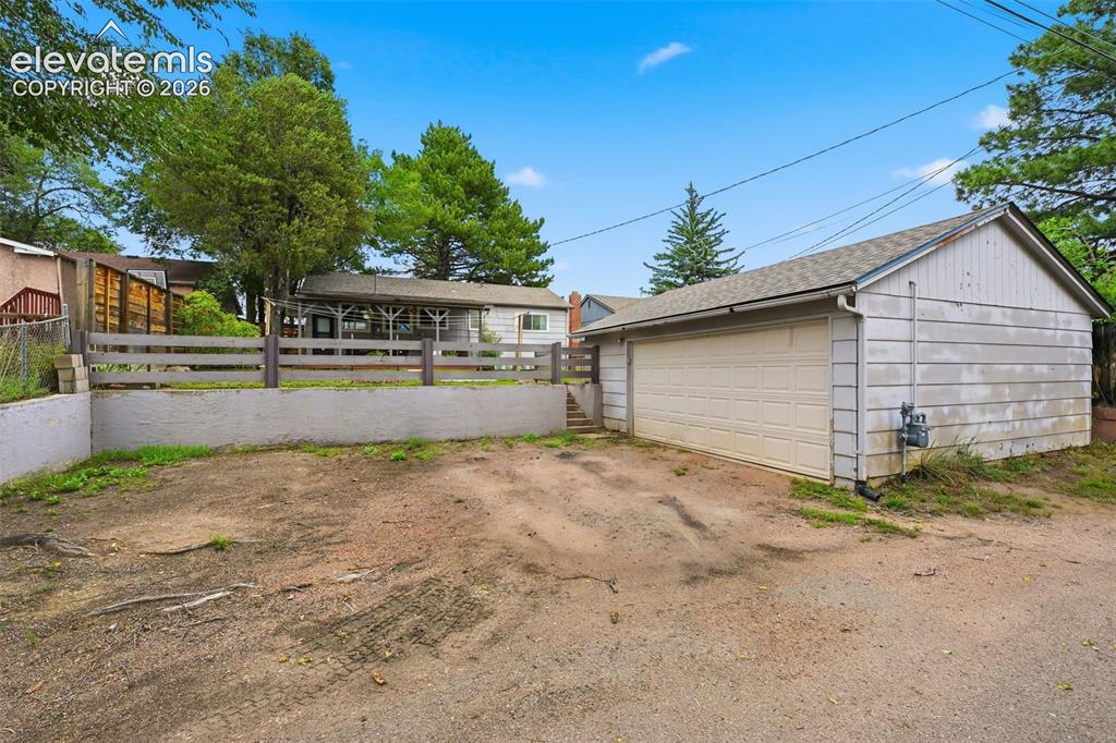 Image 7 of 30: Oversized detached 2-car garage with extra parking spaces