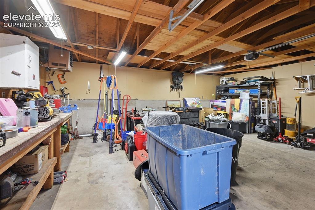 Image 8 of 30: Garage with workbench 