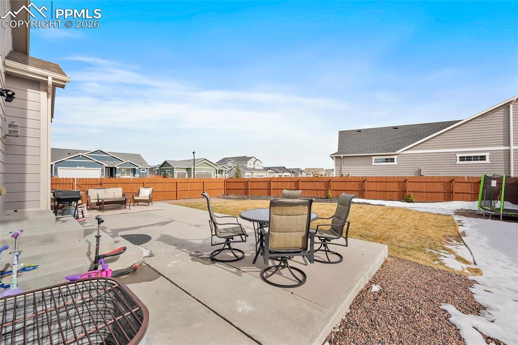 Image 40 of 43: Fenced backyard featuring outdoor dining area, a residential view, a patio,