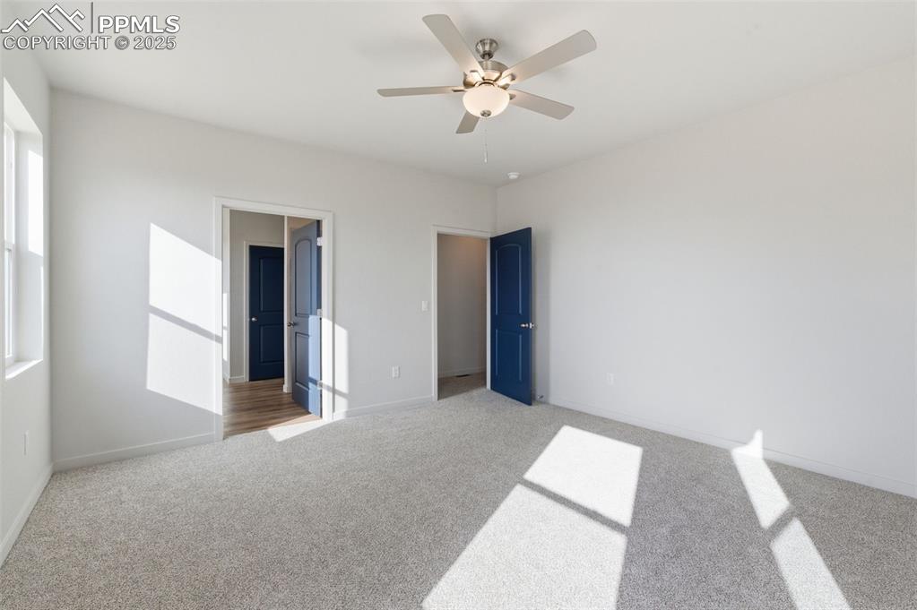 Image 19 of 26: Unfurnished bedroom featuring carpet flooring and a ceiling fan