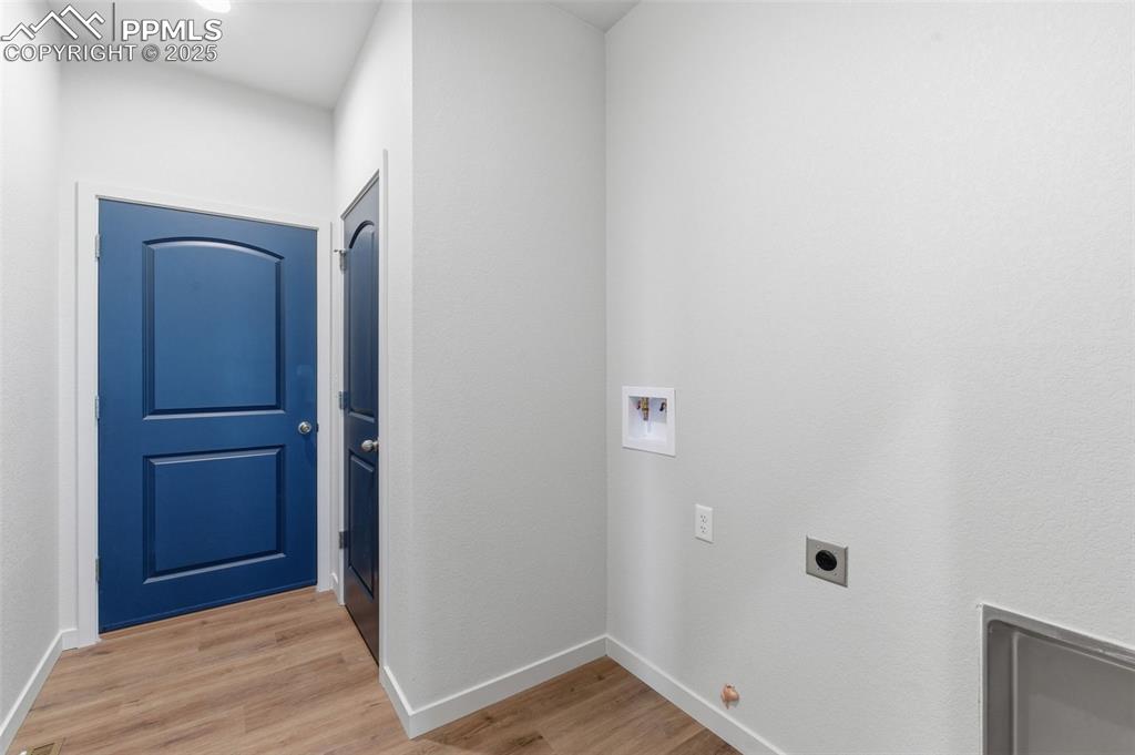 Image 26 of 26: Washroom featuring washer hookup, light wood finished floors, and electric