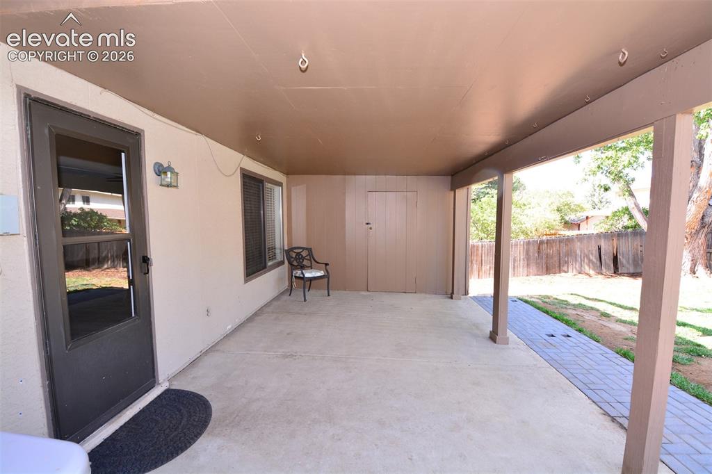 Image 16 of 33: Walk-out from the lower level family room to covered patio/backyard