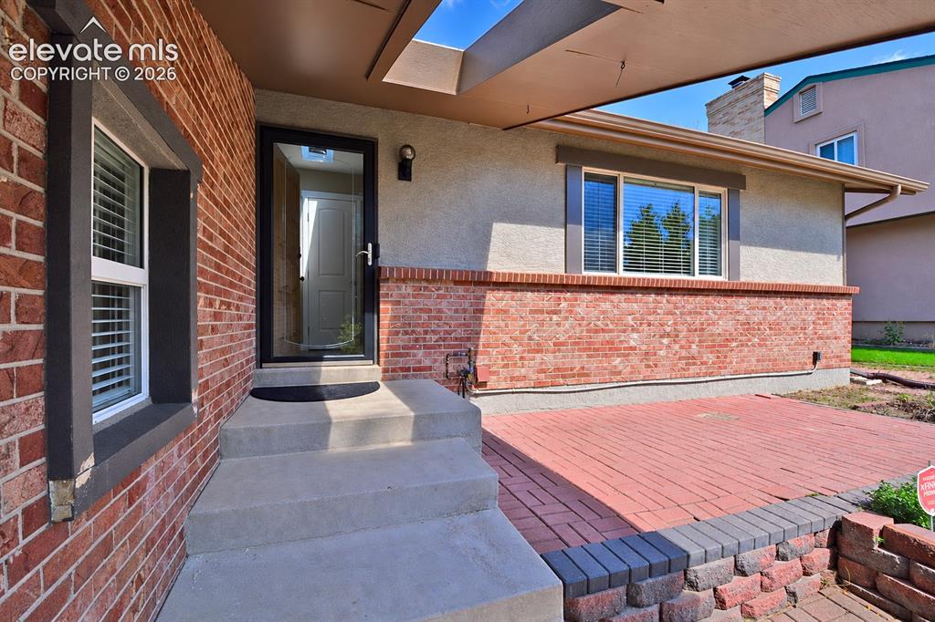 Image 2 of 33: Covered front porch with skylight