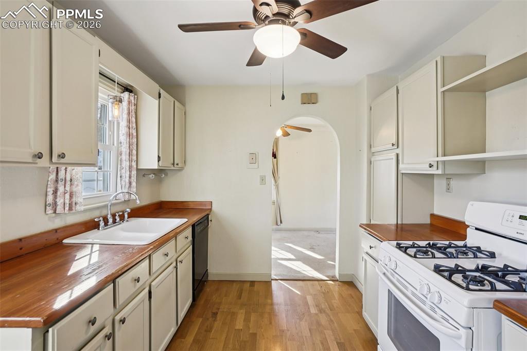 Image 11 of 48: Kitchen with gas burning stove, matching appliances and a walk out to the b