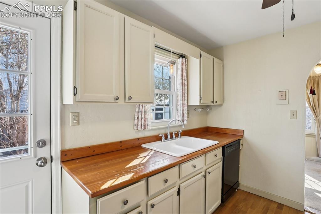 Image 13 of 48: Kitchen with gas burning stove, matching appliances and a walk out to the b