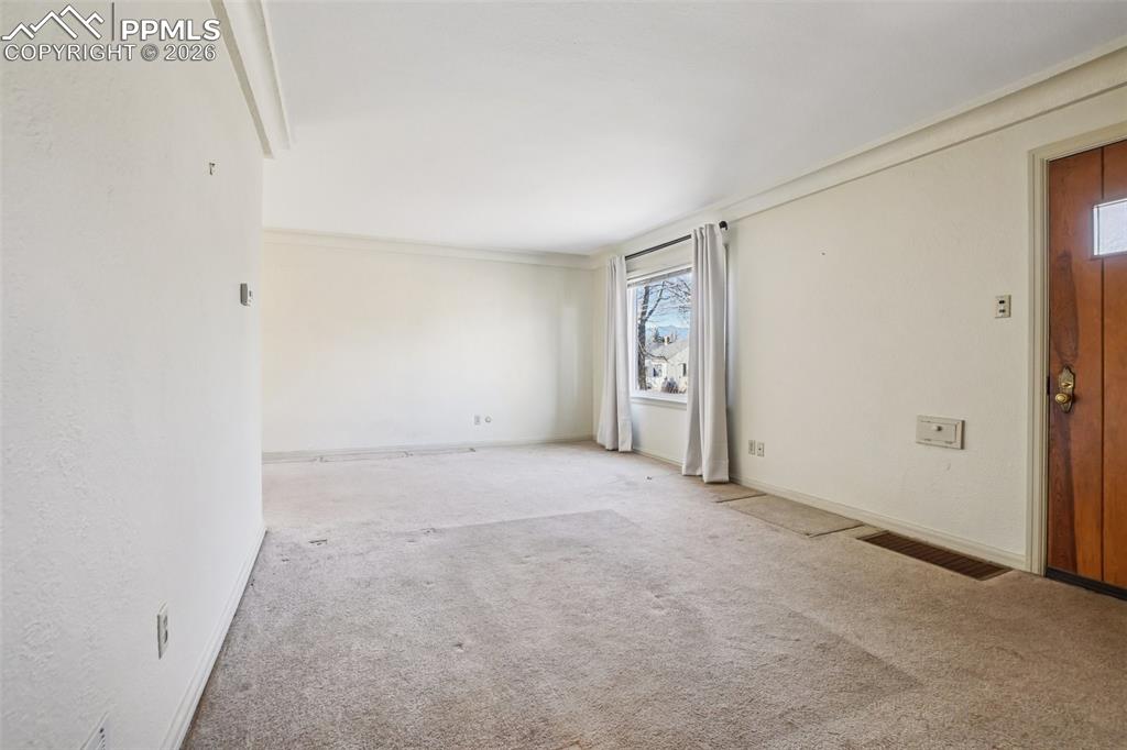 Image 4 of 48: Foyer and living room