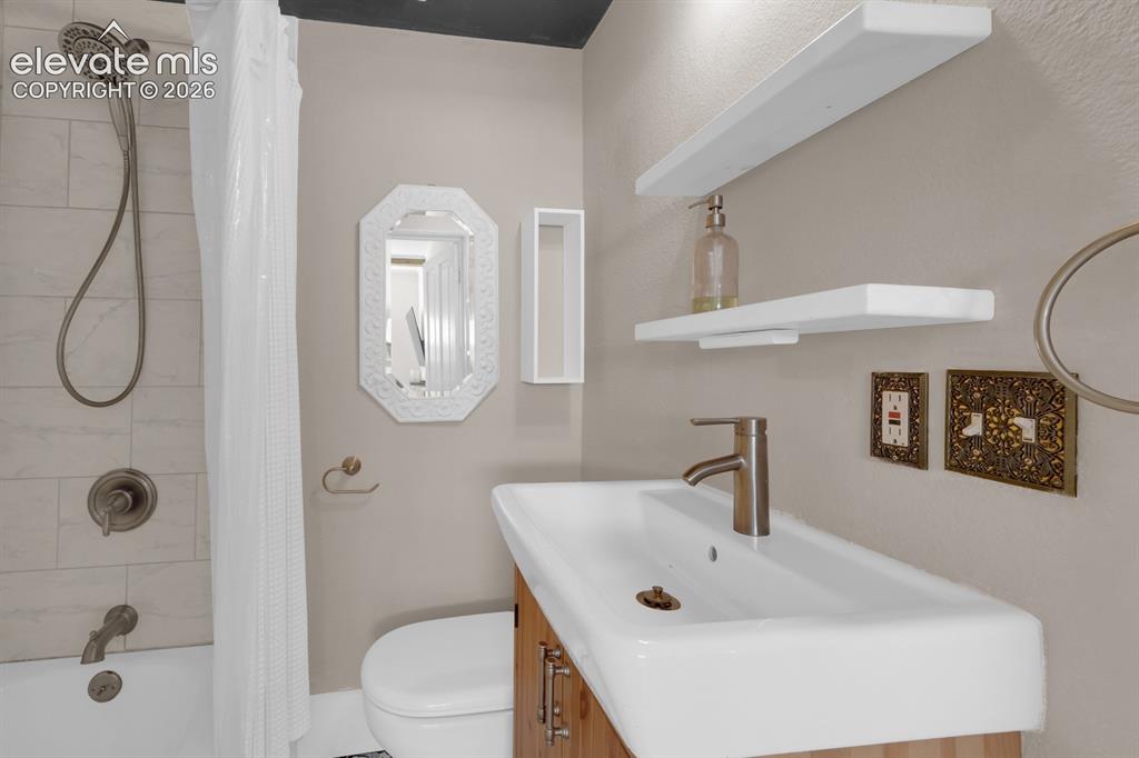 Image 14 of 32: Main level full bathroom.