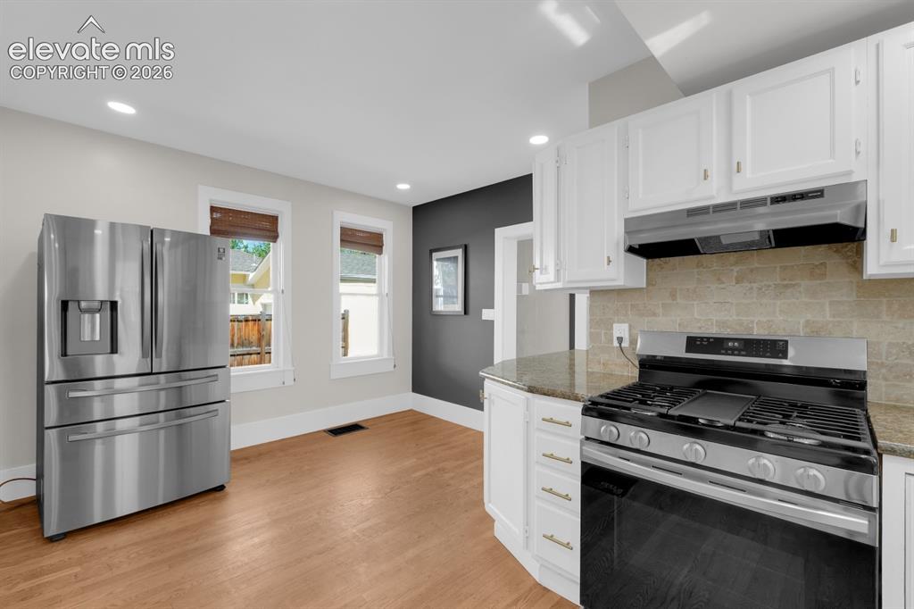 Image 9 of 32: Kitchen with updated appliances and granite counter tops.