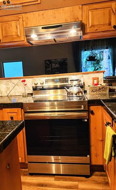 Image 14 of 46: Stainless steel range with a flat cooktop