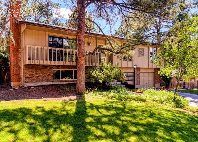 Image 2 of 46: Split-level residence featuring a brick and siding exterior