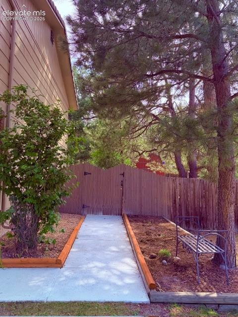Image 33 of 46: Concrete walkway from front of the house to the backyard