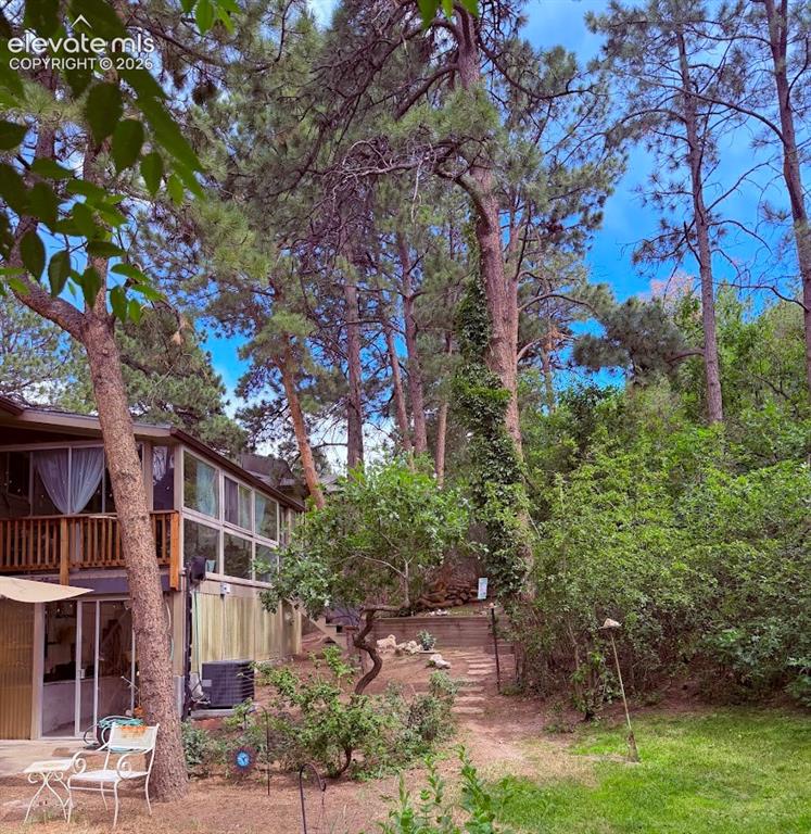 Image 41 of 46: Elevated property featuring extensive natural landscaping with mature trees