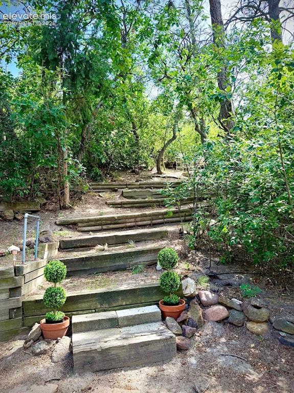 Image 45 of 46: walk-way to sitting area on small hill in back yard