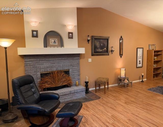 Image 7 of 46: Wood fireplace, vaulted ceilings open to dining area and back enclosed sunr