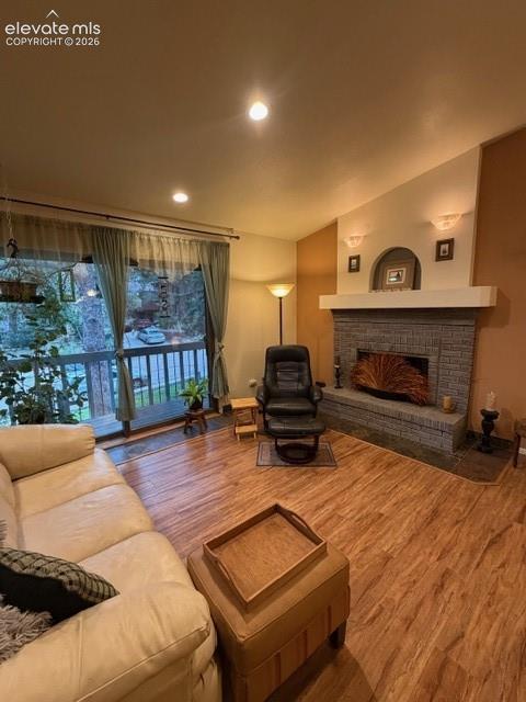 Image 8 of 46: Spacious living area featuring wood-finish flooring and an expansive window