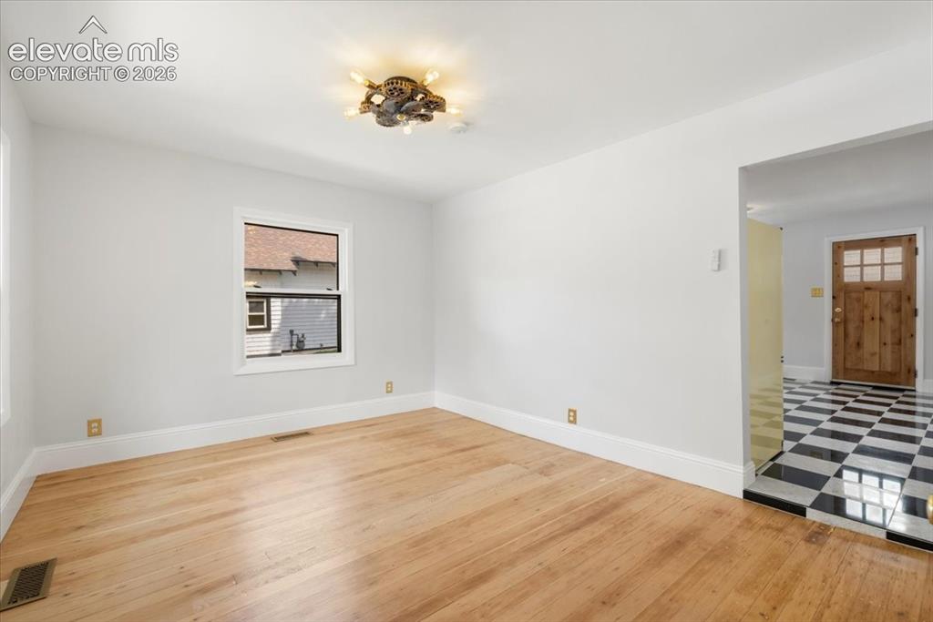 Image 10 of 30: Living room leads to kitchen