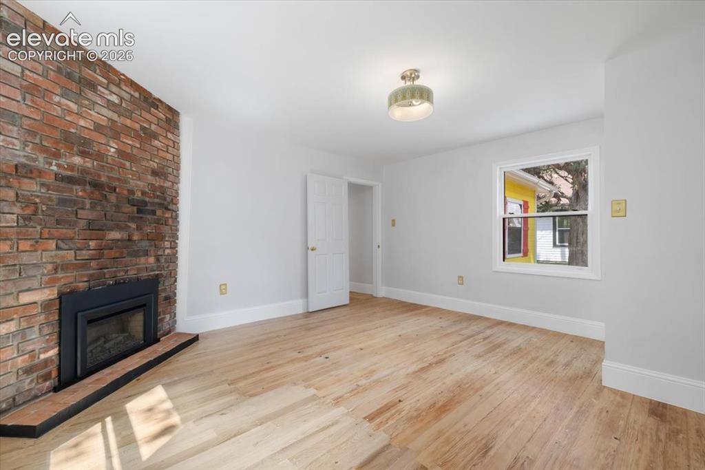 Image 14 of 30: Vintage fireplace in 1 of the 3 bedrooms