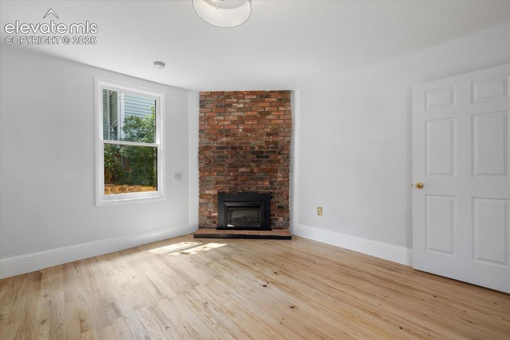 Image 15 of 30: Vintage fireplace in 1 of the 3 bedrooms