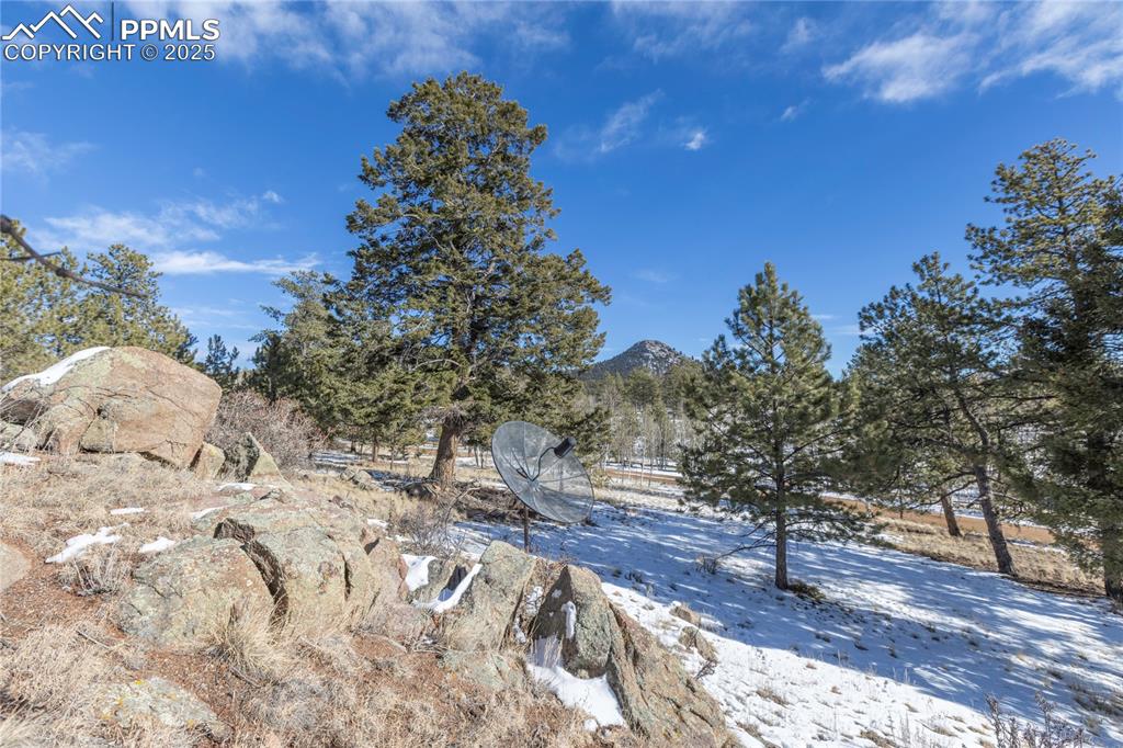 Image 6 of 33: View of the the rock structure and the satellite dish on property