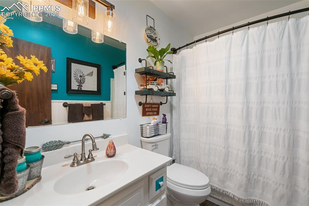 Image 15 of 45: Full bathroom featuring vanity and a shower with shower curtain