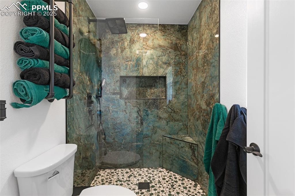 Image 19 of 45: Bathroom featuring a marble finish shower