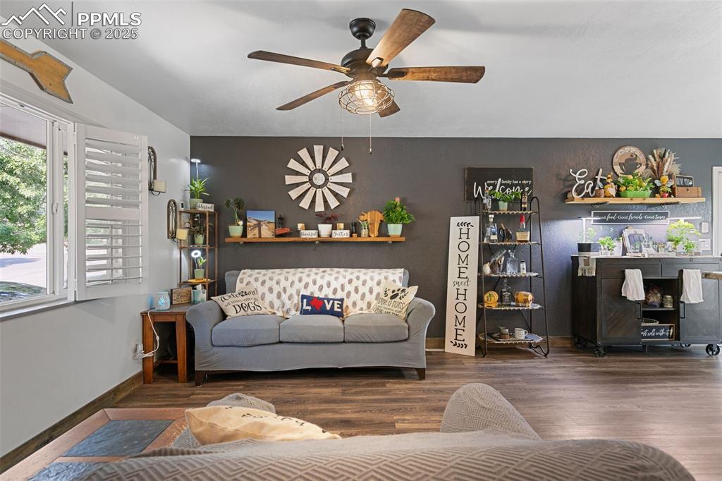 Image 31 of 45: Living area featuring wood finished floors and ceiling fan