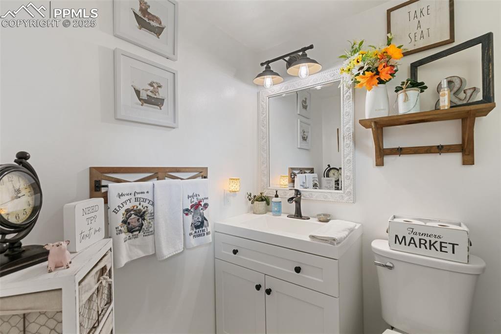 Image 36 of 45: Half bathroom with vanity and toilet