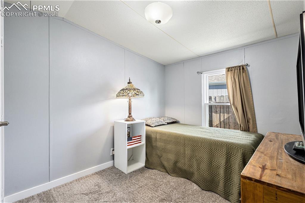 Image 16 of 18: Bedroom featuring light colored carpet and baseboards
