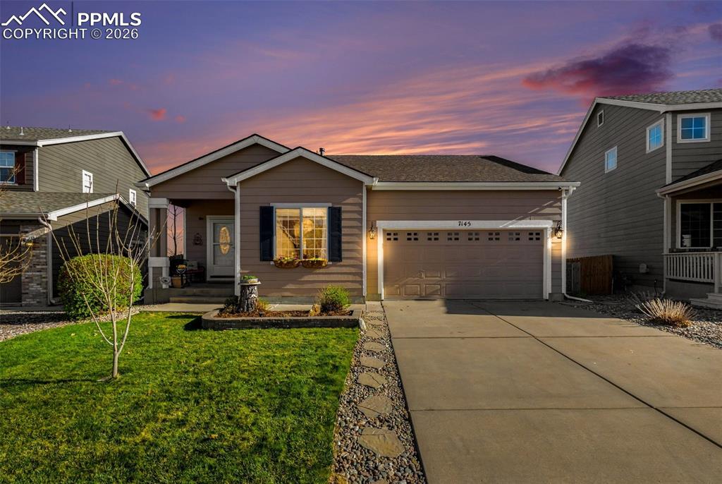 Image 1 of 42: View of front of property featuring driveway, an attached garage, a front l