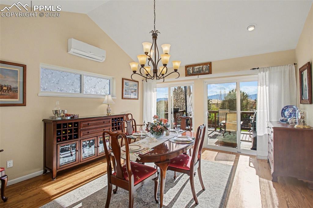 Image 13 of 42: Dining room with lofted ceiling, light wood finished floors, healthy amount