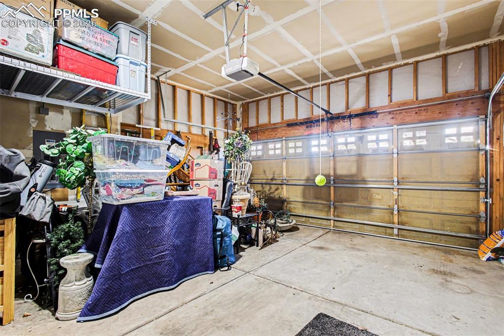 Image 34 of 42: Garage featuring a garage door opener