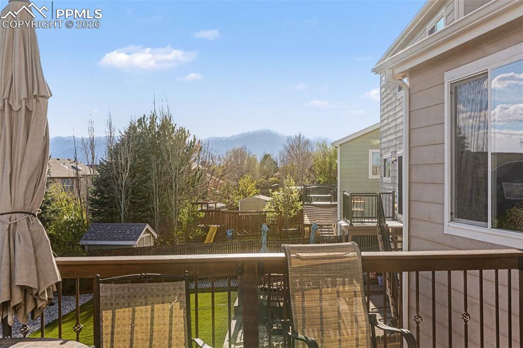 Image 39 of 42: Wooden terrace featuring a mountain view and an outbuilding