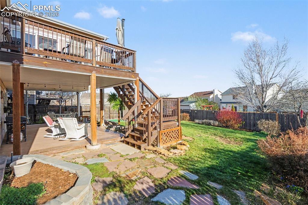 Image 40 of 42: Fenced backyard featuring a deck and a patio area