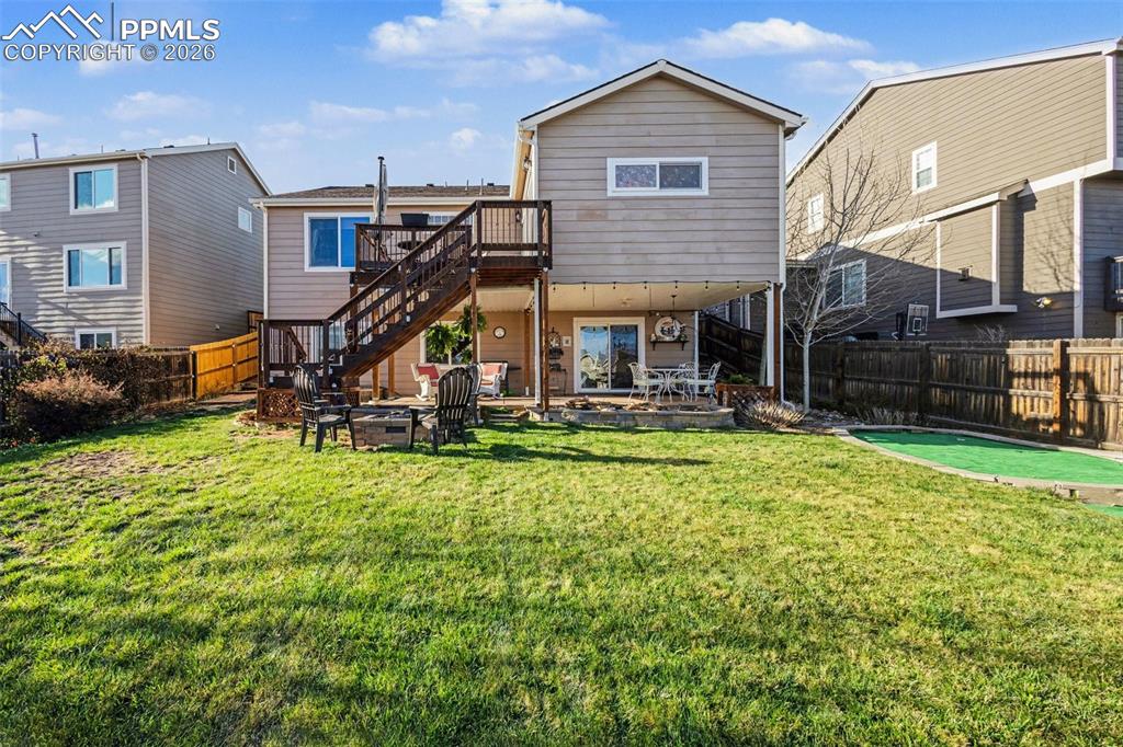 Image 42 of 42: Back of property with a deck, a patio area, and a fenced backyard