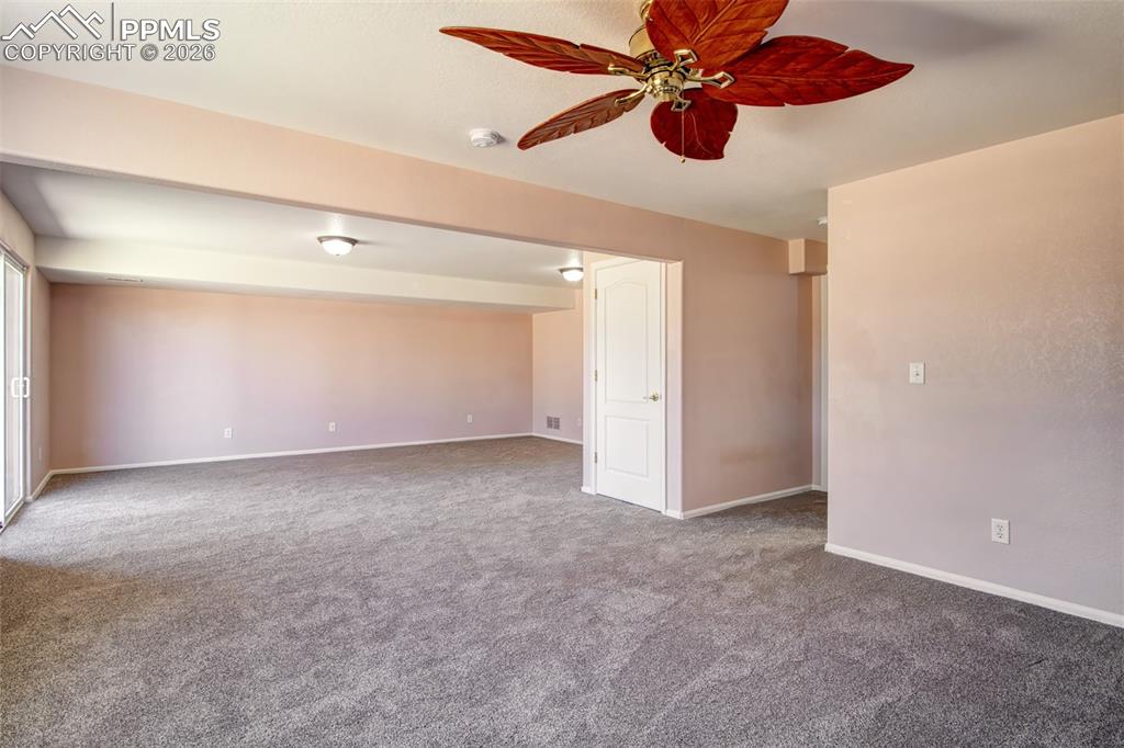 Image 19 of 33: Recreation room in basement with walk out to covered patio