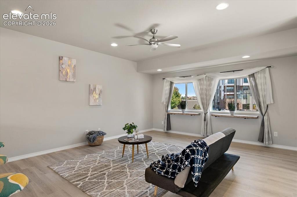 Image 12 of 31: Recessed ceiling lighting, wood-finish flooring, and multiple windows with
