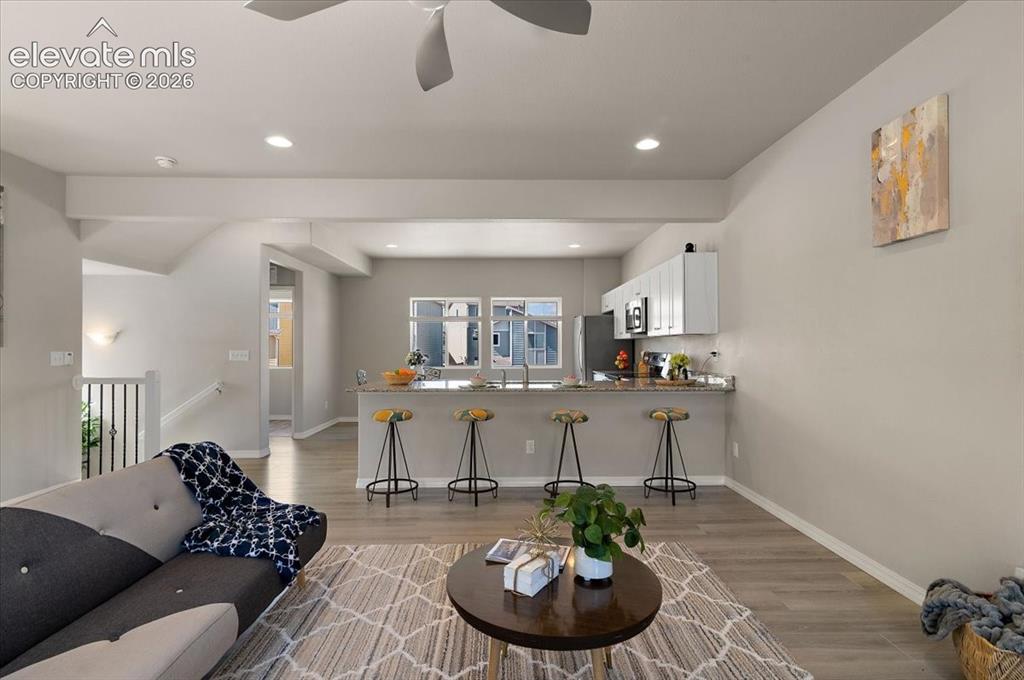 Image 13 of 31: Open-concept living area w recesselighting, and a ceiling fan