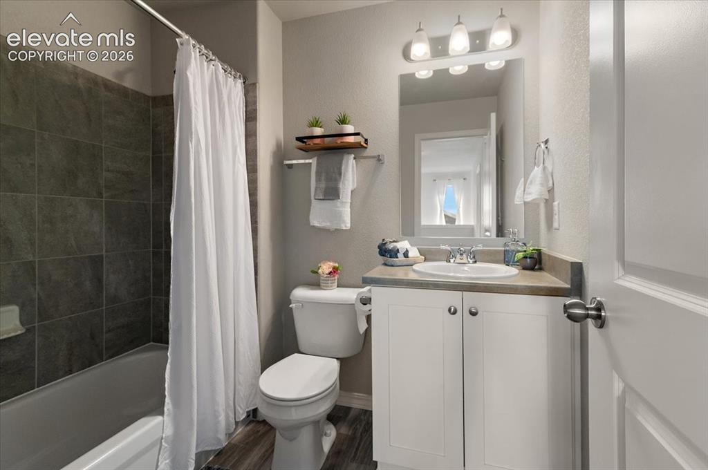 Image 25 of 31: White vanity with a single basin sink and stainless-steel faucet