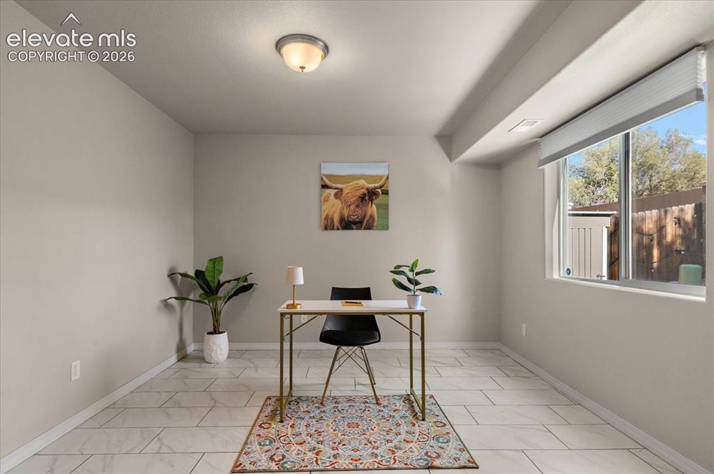 Image 5 of 31: Recessed lighting and a single window provide illumination to this neutral-