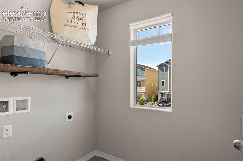 Image 9 of 31: Single window, wood-finish flooring, and light gray wall paint