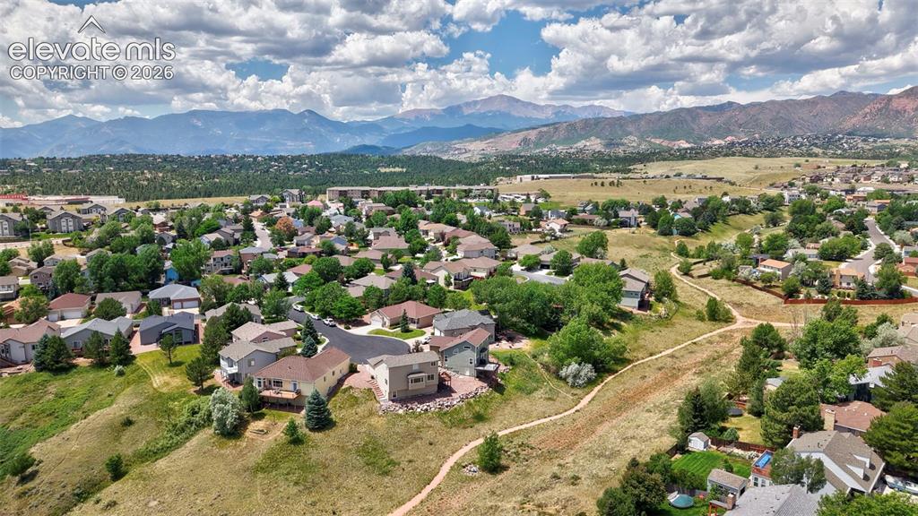 Image 14 of 50: Expansive landscape featuring residential properties and surrounding terrai
