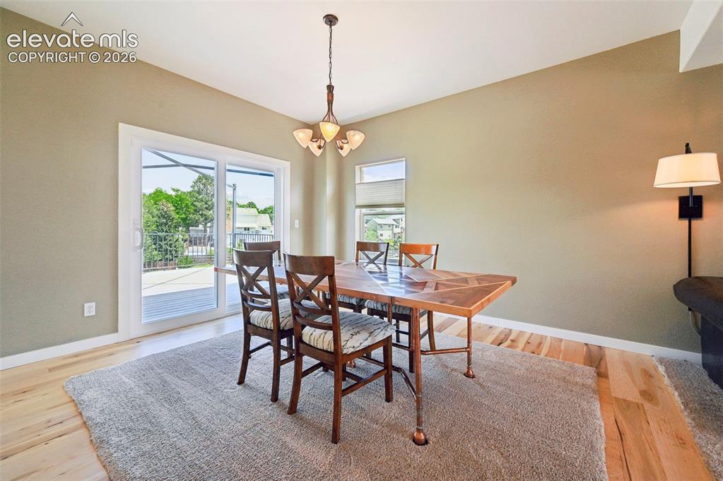 Image 22 of 50: Light wood-finish flooring with a textured area rug