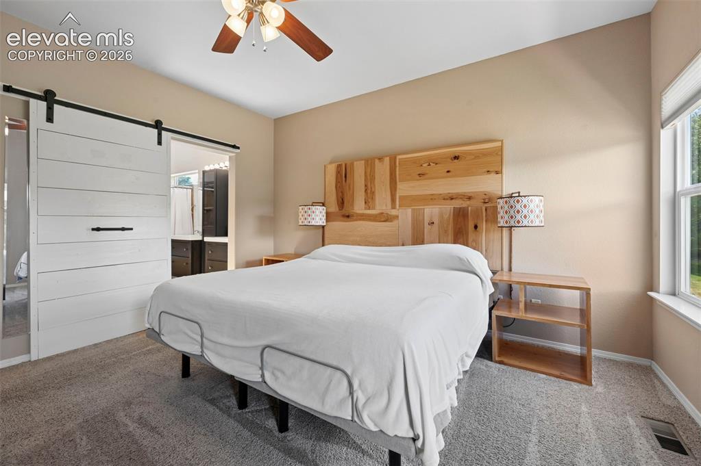 Image 31 of 50: Spacious bedroom featuring neutral wall tones, gray carpeting, and a ceilin
