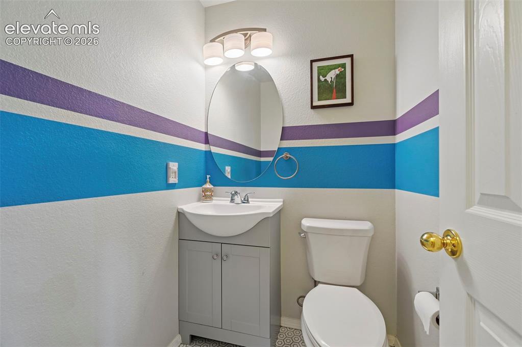 Image 44 of 50: Powder room featuring a pedestal sink with storage vanity, oval mirror, and