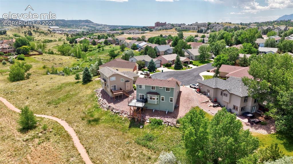 Image 5 of 50: Expansive property featuring a green exterior, multiple levels, and a rear