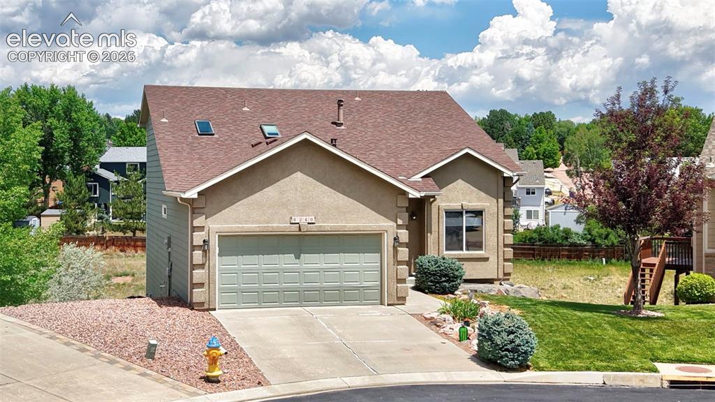 Image 7 of 50: Stucco exterior with an attached two-car garage