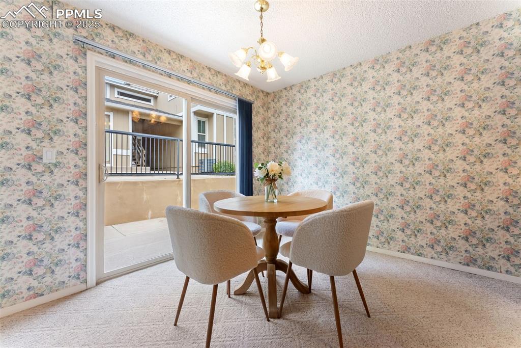 Image 10 of 30: Dining room right off the kitchen with a walkout to the back patio