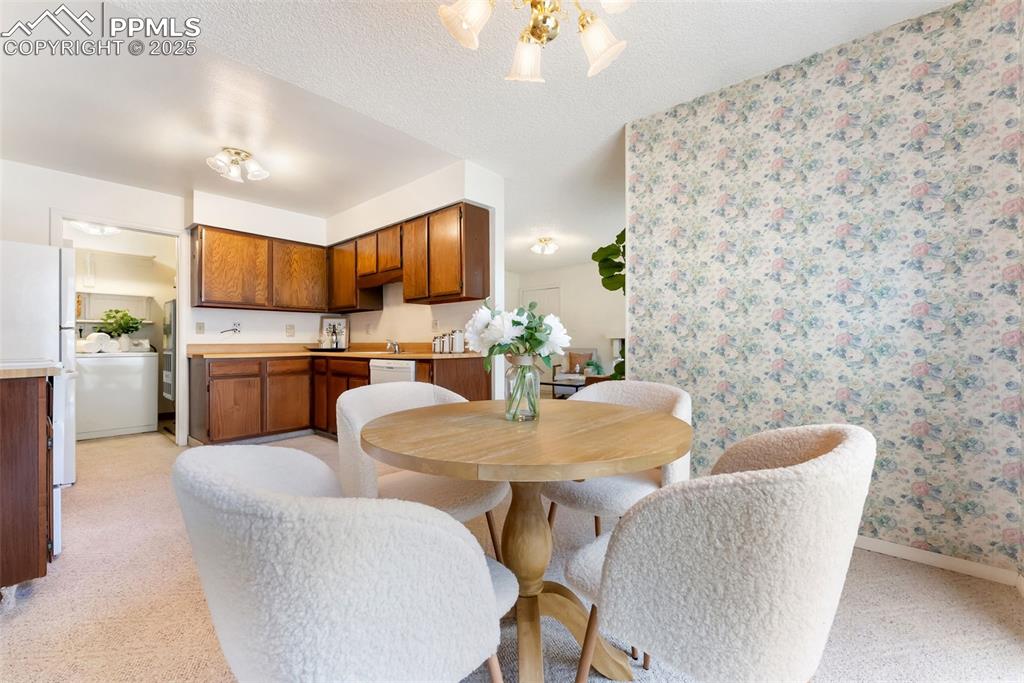 Image 12 of 30: Dining room right off the kitchen with a walkout to the back patio