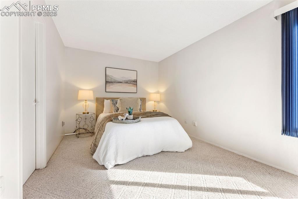 Image 13 of 30: Large primary bedroom with double closets, sitting/dressing area and an ens